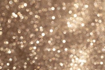 Golden bokeh background with shimmering light sparkles and abstract circular patterns