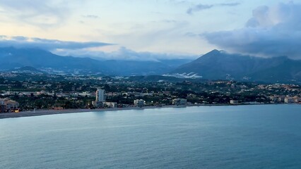 Gorgeous Serene Coastal View Featuring Majestic Mountains and Calm Tranquil Waters