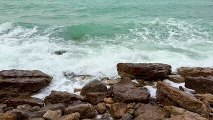 Dynamic Coastal Waves with Powerful Energy Crashing Gracefully on Rocky Shoreline