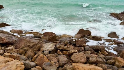 Waves are crashing upon the rocky shoreline in this stunning and beautiful coastal scene