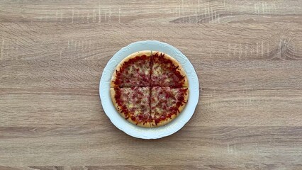 Enjoy a Delicious Pizza topped with Cheese and Ham, Perfect for Any Social Gathering or Event