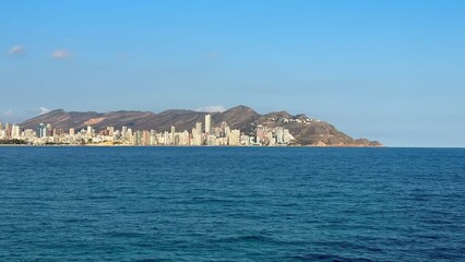 Fototapeta premium Take a moment to enjoy the stunning coastal view showcasing a majestic city skyline by the sea