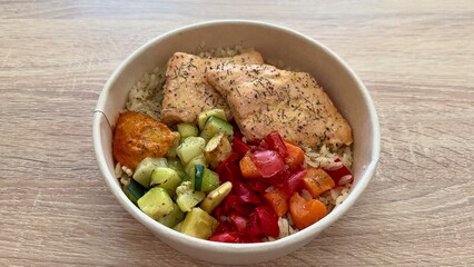 A Healthy and Delicious Salmon Bowl Served with Colorful Fresh Vegetables and Rice