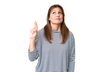 Middle age woman over isolated background with fingers crossing and wishing the best
