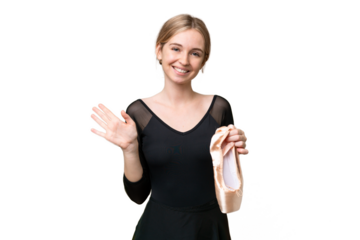 Young English woman practicing ballet over isolated background saluting with hand with happy expression
