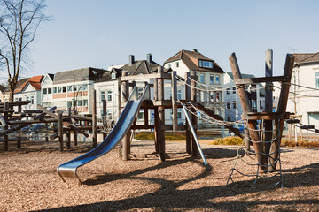 Urban playground with a slide in the open air. Wooden playground.
