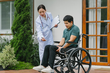 Doctor Examining Patient in Wheelchair Outdoors