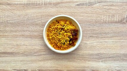 A delicious and vibrant yellow rice dish enriched with spices and a variety of ingredients