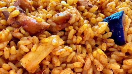 Delicious and flavorful Jollof Rice served with tender Chicken and fresh Vegetables included