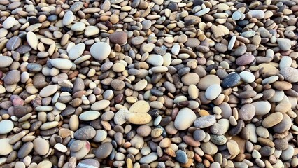 A picturesque and scenic Pebble Beach, featuring calm waters and gentle, soothing waves