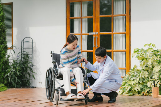 Doctor Assisting Patient in Wheelchair - Powered by Adobe