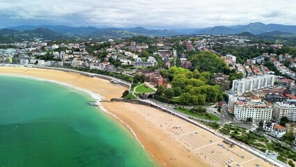 A stunning aerial view of a picturesque beach and a vibrant coastal city landscape