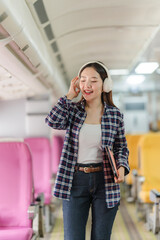 Young Woman Listening to Music on Train