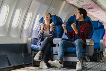 Excited Couple Traveling by Airplane