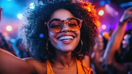 Woman enjoying a vibrant music concert.  Smiling, dancing, and having fun