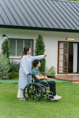 Caregiver Assisting Man in Wheelchair Outdoors