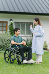 Caring Doctor Supporting Patient in Wheelchair