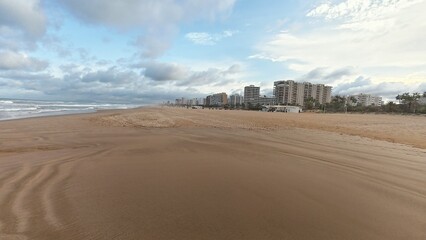 A Serene Coastal Beach View Showcasing Beautiful Coastal Buildings Beneath Cloudy Skies