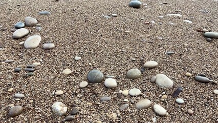 Enjoy the Serene Seaside Pebbles along with Gentle Waves crashing on Sandy Beach