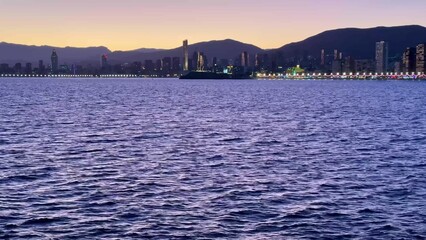 A Stunning Coastal Sunset Featuring a Magnificent City Skyline Reflection for All to Enjoy