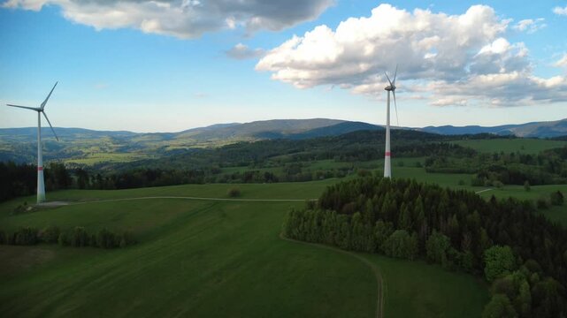 Wind turbines in the Jesen&iacute;ky Mountains near Hanu&scaron;ovice and Doln&iacute; Morava, Czech Republic. Scenic view of renewable energy infrastructure set in a natural mountain landscape with rolling hills, forests