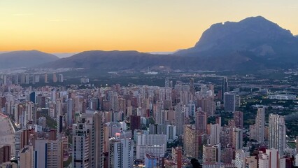 A breathtaking view of a stunning coastal cityscape as the sun rises over the horizon