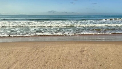 Gentle sea relaxing waves on a sandy beach