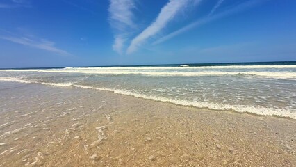 A Tranquil Beach Full of Clear Crystal Waters and Beautiful Blue Skies Awaiting Your Visit