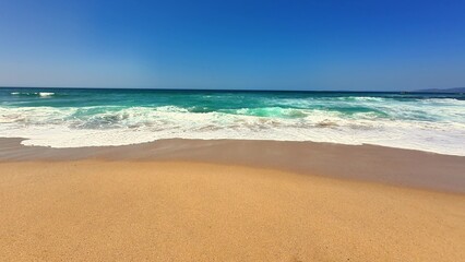A Serene Beach Landscape Showcasing Crystal Clear Waves Gently Rolling onto Soft Sandy Shores