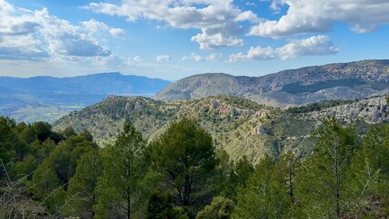 Experience the breathtaking beauty of a stunning mountain view with lush greenery and blue skies