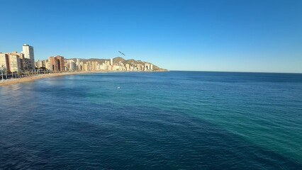 Fototapeta premium Enjoy the stunning coastal view of Benidorm, beautifully framed by a clear blue sky