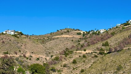 Experience a breathtaking hilltop view of luxury homes against a beautiful blue sky