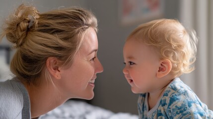 Blonde mother and her infant share a joyful moment at home.