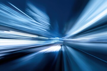 Dynamic blue light trails on urban street at night.