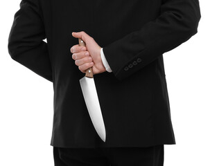 Businessman holding knife behind his back on white background, closeup