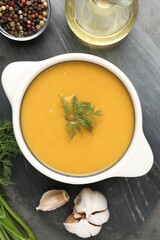 Delicious lentil cream soup with dill served on grey table, top view