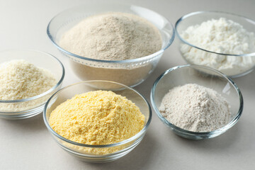 Different types of flour on white background, closeup