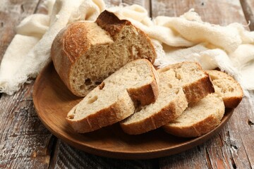 Pieces of fresh bread on wooden table, closeup