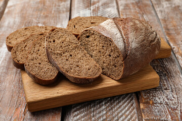 Pieces of fresh bread on wooden table, closeup