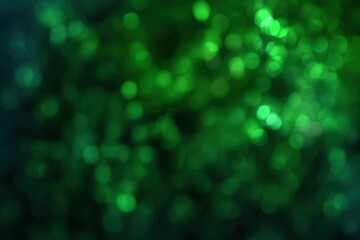Obraz premium Abstract green bokeh background with light spots.