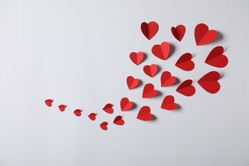 Many paper hearts on light grey background, flat lay