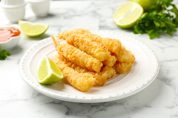 Tasty tempura shrimps served on white marble table, closeup