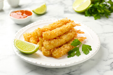Tasty tempura shrimps served on white marble table, closeup