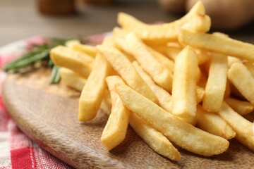 Fresh tasty french fries on table, closeup