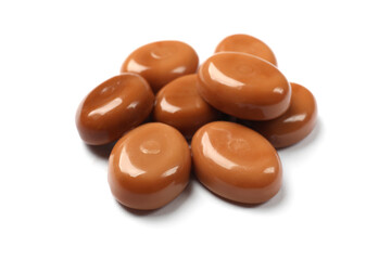 Tasty sweet caramel candies isolated on white