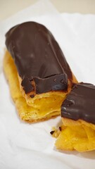 Delightful pastry creation with rich chocolate topping, enjoyed at a cozy café during afternoon break