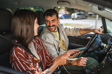 adult woman girlfriend using mobile phone while drive with boyfriend