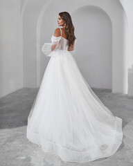 Elegant Woman in Wedding Dress in Studio