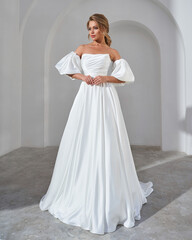 Fototapeta premium Elegant Bride in Off-Shoulder White Wedding Dress