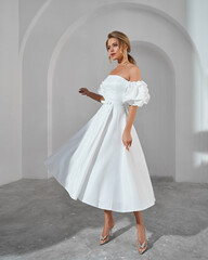 Elegant woman in white dress with puff sleeves